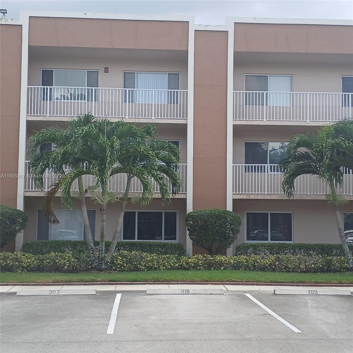 7136 South Devon Drive, Unit 207 Tamarac, FL 33321 - Photo 3 of 24 a front view of a house with a garden