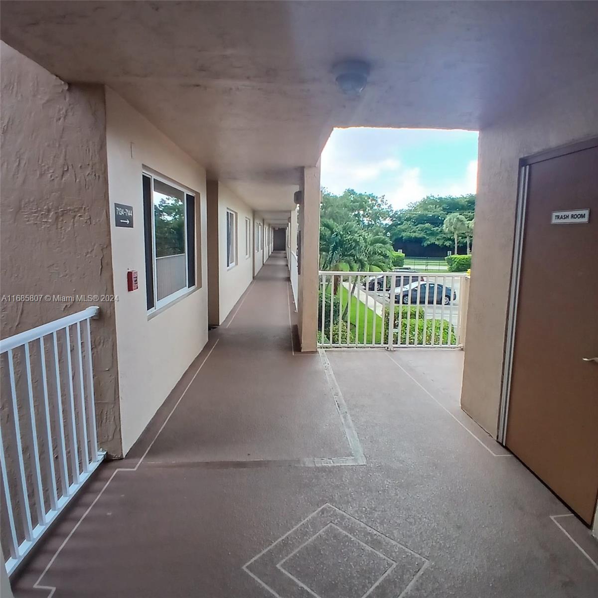7136 South Devon Drive, Unit 207 Tamarac, FL 33321 - Photo 8 of 24 a view of a porch with wooden floor and a yard