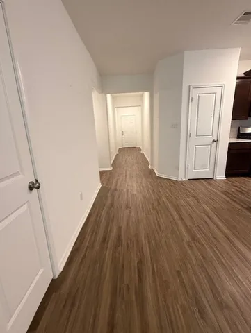 a view of a room with wooden floor and stairs