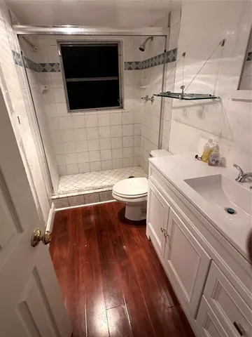 a view of a room with wooden floor and windows