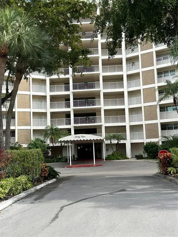a front view of a building with a yard