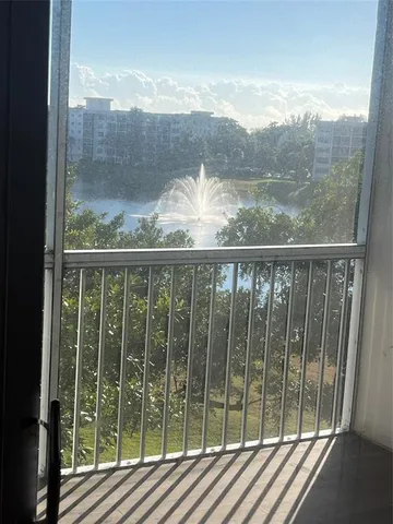 a view of a balcony with wooden floor and outdoor space
