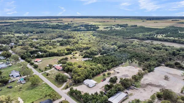 an aerial view of a houses with a yard