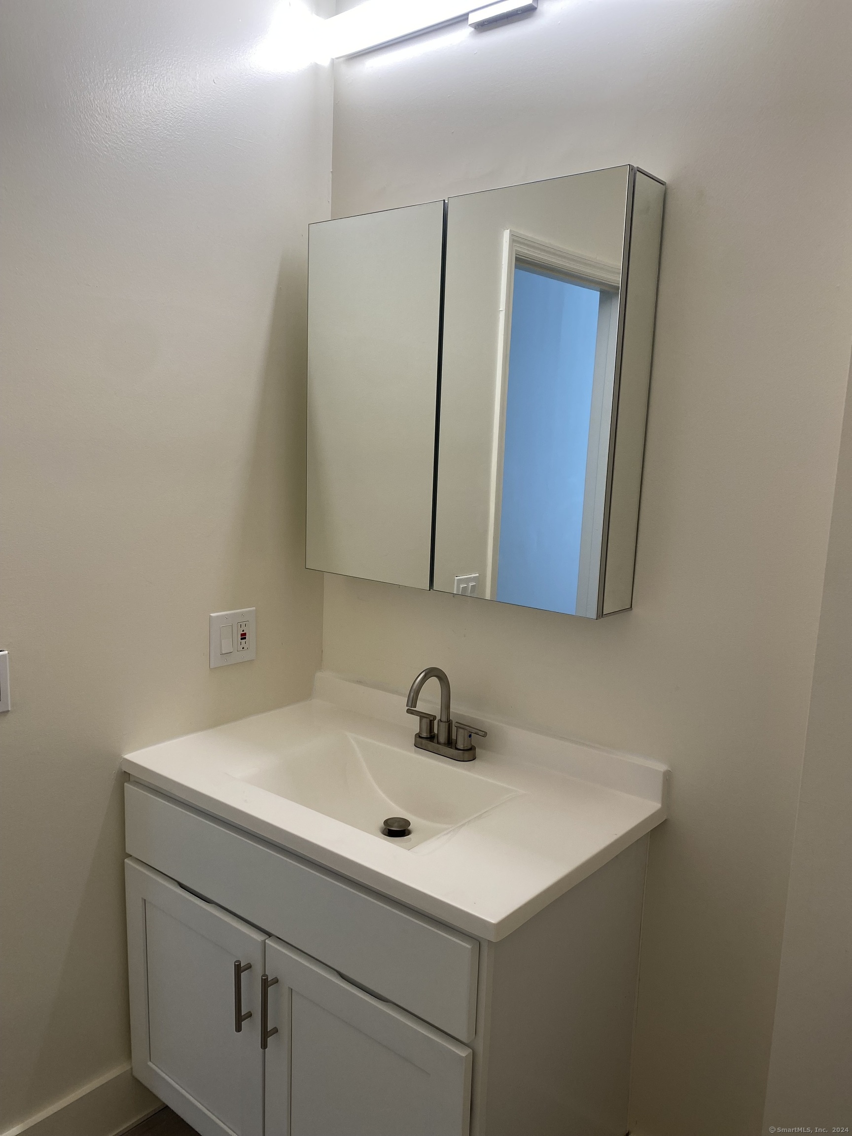 75 Prospect Street Stamford, CT 06901 - Photo 12 of 15 a bathroom with a sink and a mirror