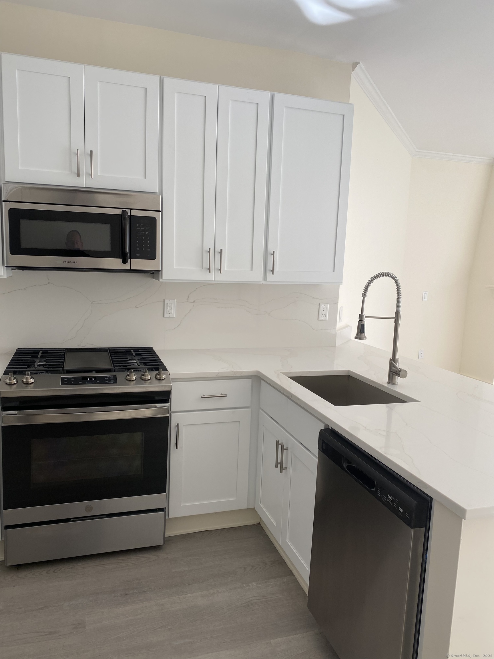 75 Prospect Street Stamford, CT 06901 - Photo 10 of 15 a kitchen with granite countertop a stove sink and cabinets