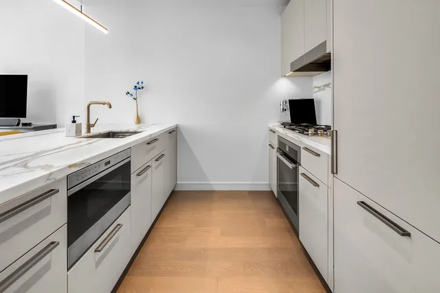a kitchen with stainless steel appliances a stove and a microwave
