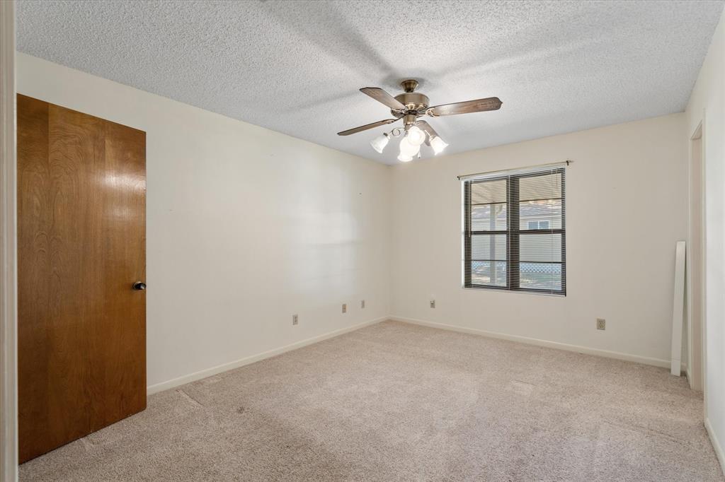 2711 Tin Top Road Weatherford, TX 76087 - Photo 17 of 22 an empty room with windows and fan