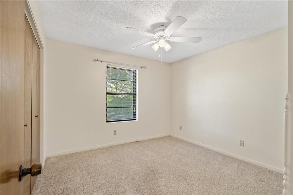2711 Tin Top Road Weatherford, TX 76087 - Photo 19 of 22 an empty room with windows and fan