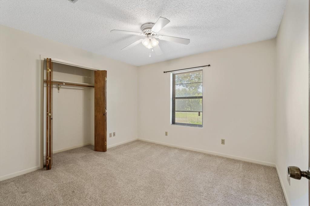 2711 Tin Top Road Weatherford, TX 76087 - Photo 20 of 22 an empty room with windows and closet