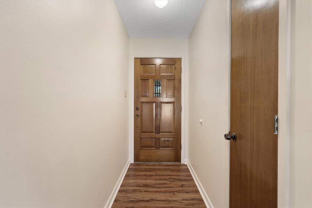 2711 Tin Top Road Weatherford, TX 76087 - Photo 5 of 22 a view of a hallway with wooden floor
