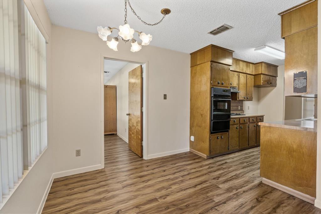 2711 Tin Top Road Weatherford, TX 76087 - Photo 9 of 22 a kitchen with stainless steel appliances a refrigerator and a stove top oven