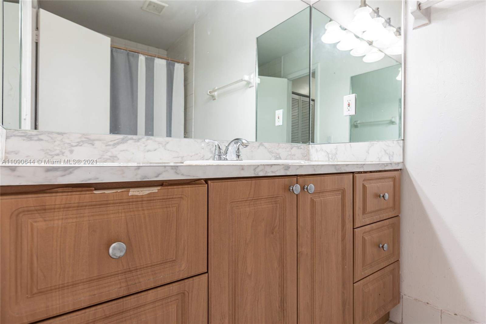 1925 Southwest 118th Court, Unit 138 Miami, FL 33175 - Photo 12 of 15 a bathroom with a granite countertop sink a vanity and a mirror