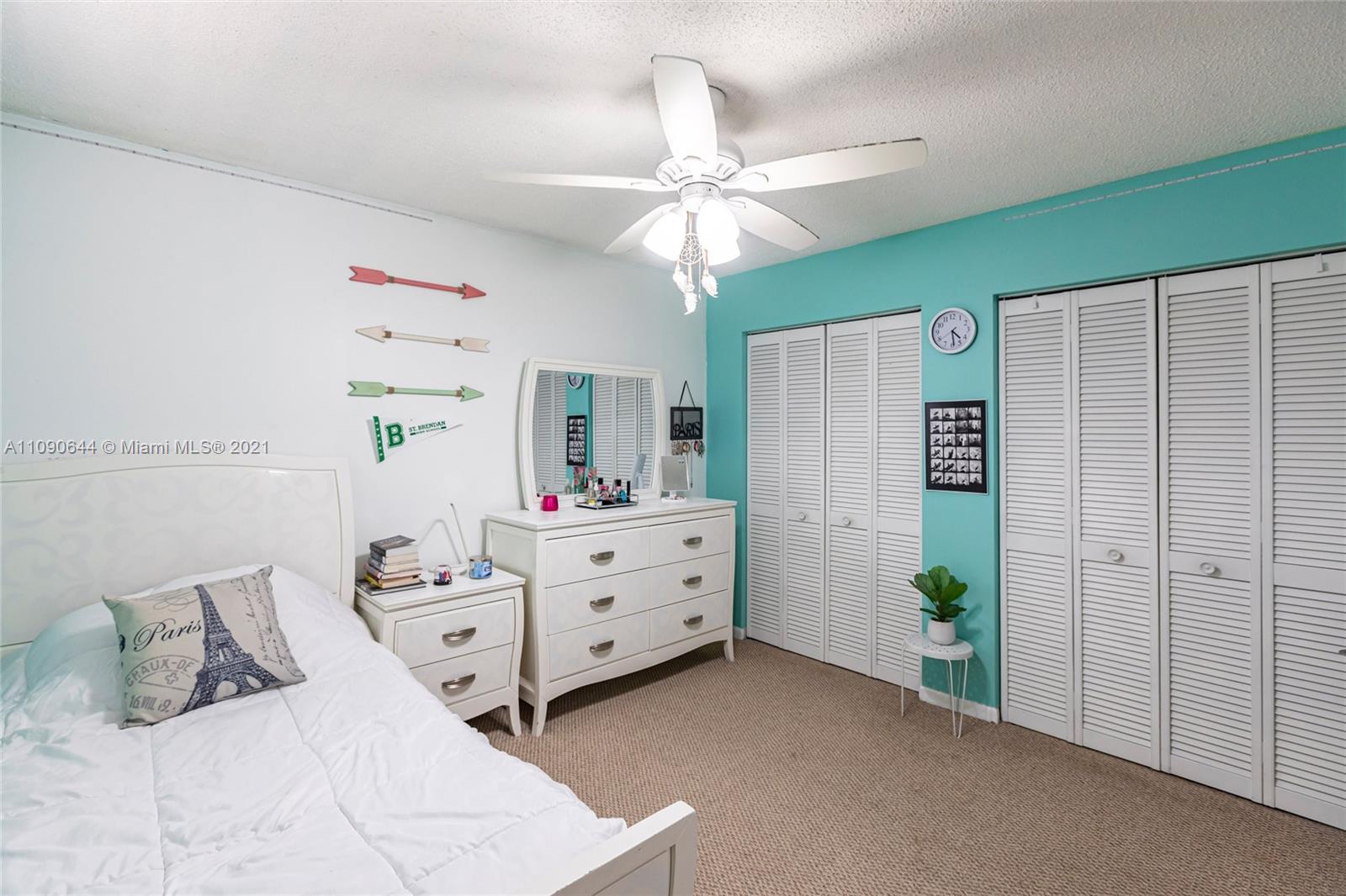 1925 Southwest 118th Court, Unit 138 Miami, FL 33175 - Photo 13 of 15 a bed room with a bed window and a ceiling fan