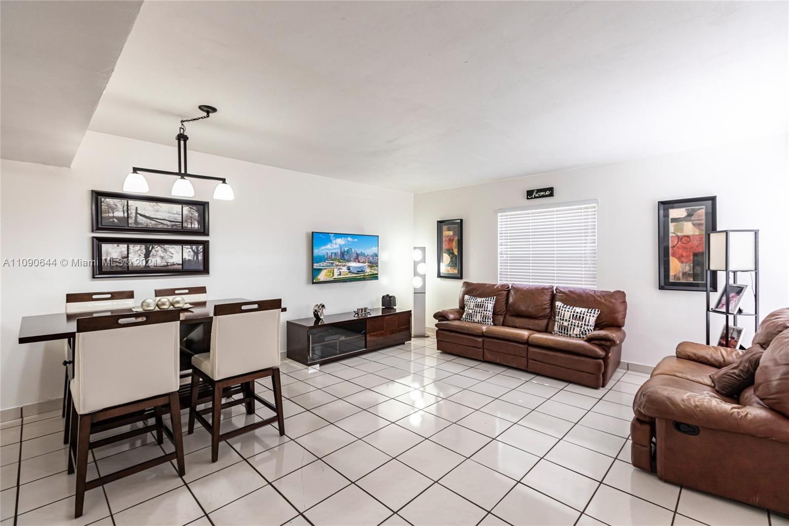 1925 Southwest 118th Court, Unit 138 Miami, FL 33175 - Photo 3 of 15 a living room with furniture a rug and white walls