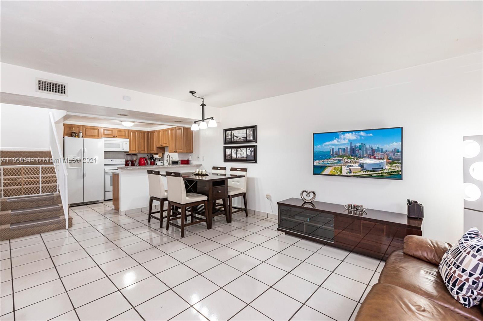 1925 Southwest 118th Court, Unit 138 Miami, FL 33175 - Photo 4 of 15 a living room with furniture a piano and a flat screen tv