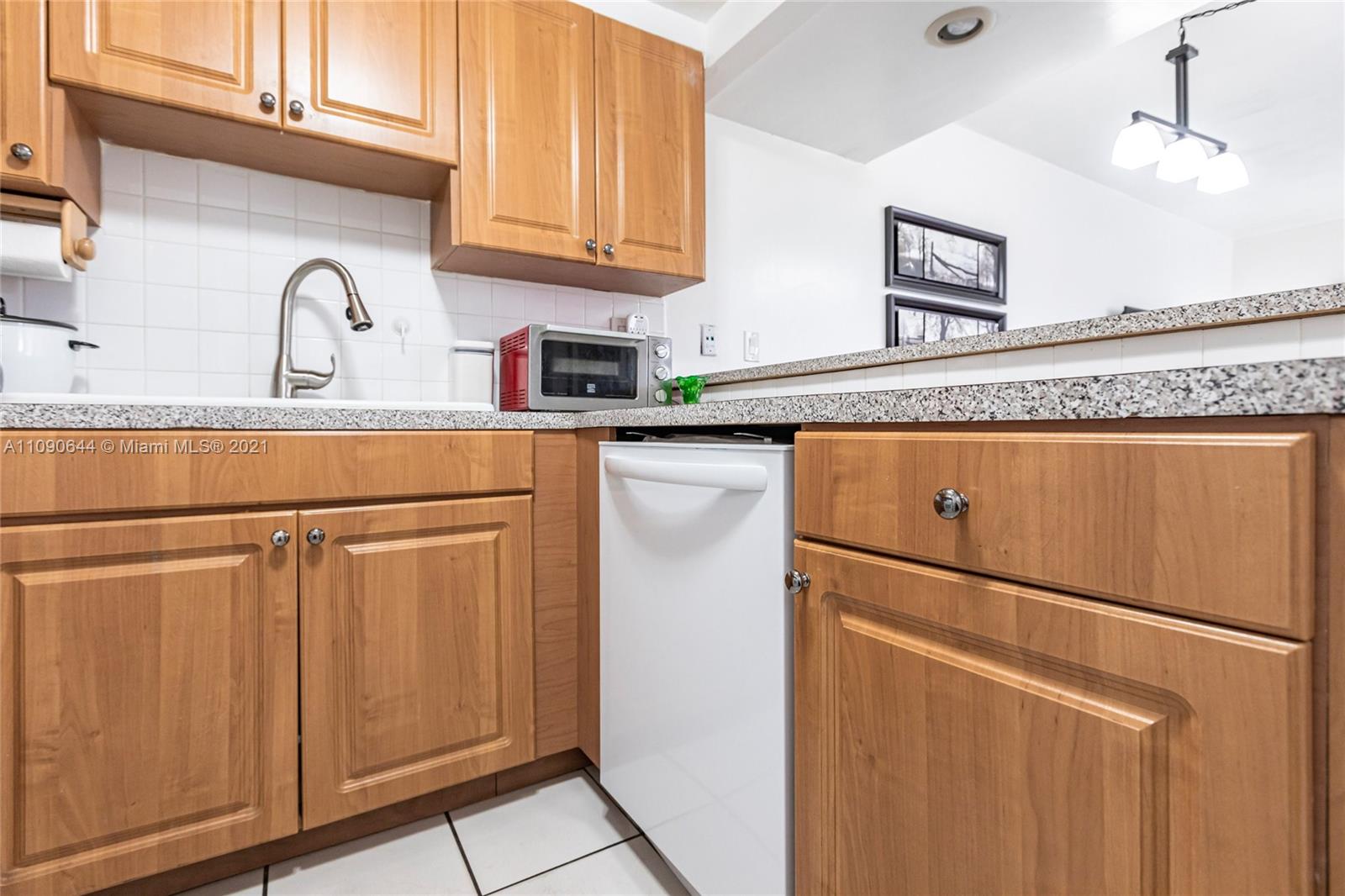 1925 Southwest 118th Court, Unit 138 Miami, FL 33175 - Photo 6 of 15 a kitchen with stainless steel appliances granite countertop a refrigerator sink and cabinets