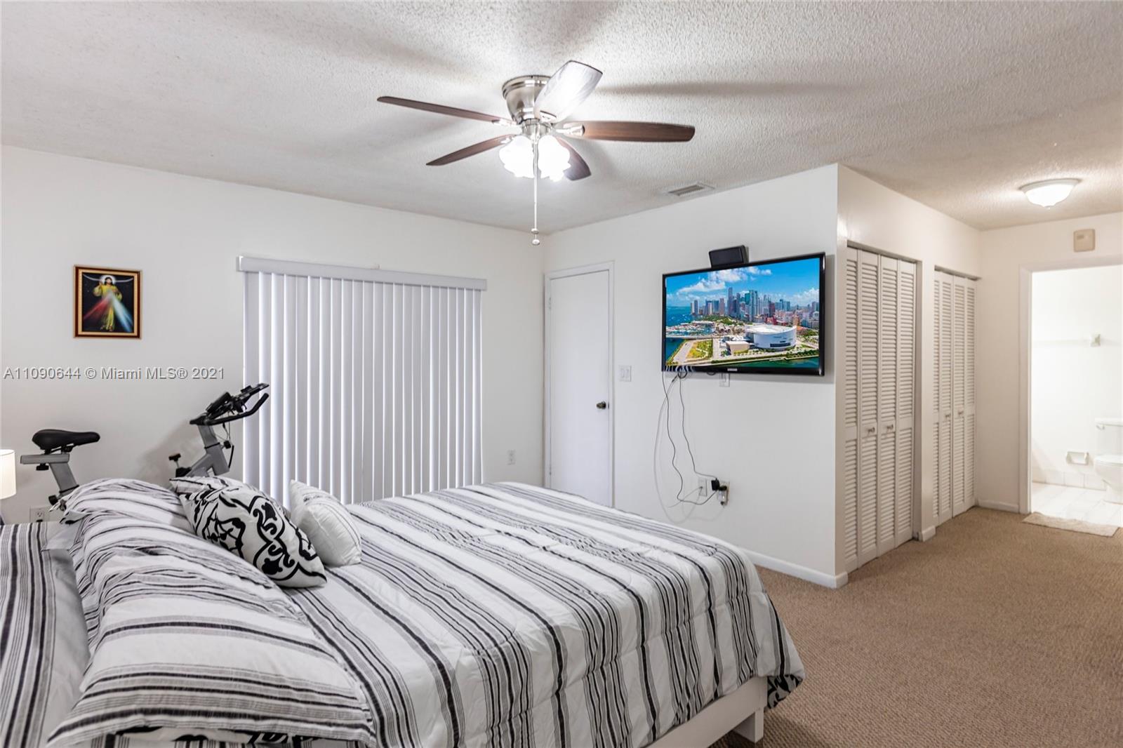 1925 Southwest 118th Court, Unit 138 Miami, FL 33175 - Photo 10 of 15 a bedroom with bed and a chandelier