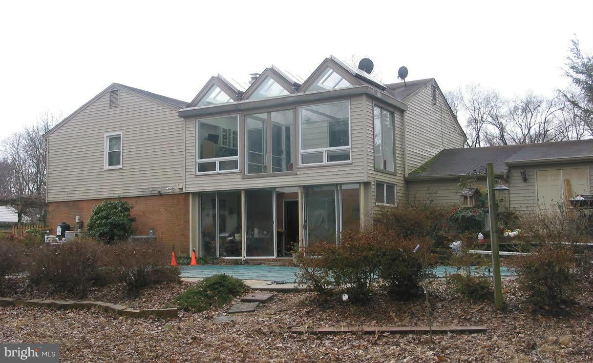 2416 Parallel Lane Silver Spring, MD 20904 - Photo 22 of 22 a view of a white house next to a yard and potted plants