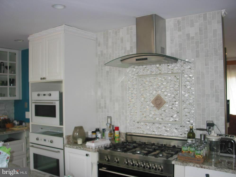 2416 Parallel Lane Silver Spring, MD 20904 - Photo 4 of 22 a kitchen with granite countertop a stove and a sink