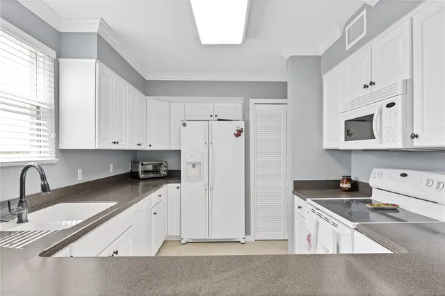 a bedroom with a bed a couch and a window