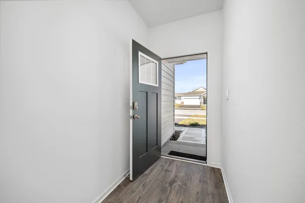 a view of a room with wooden floor