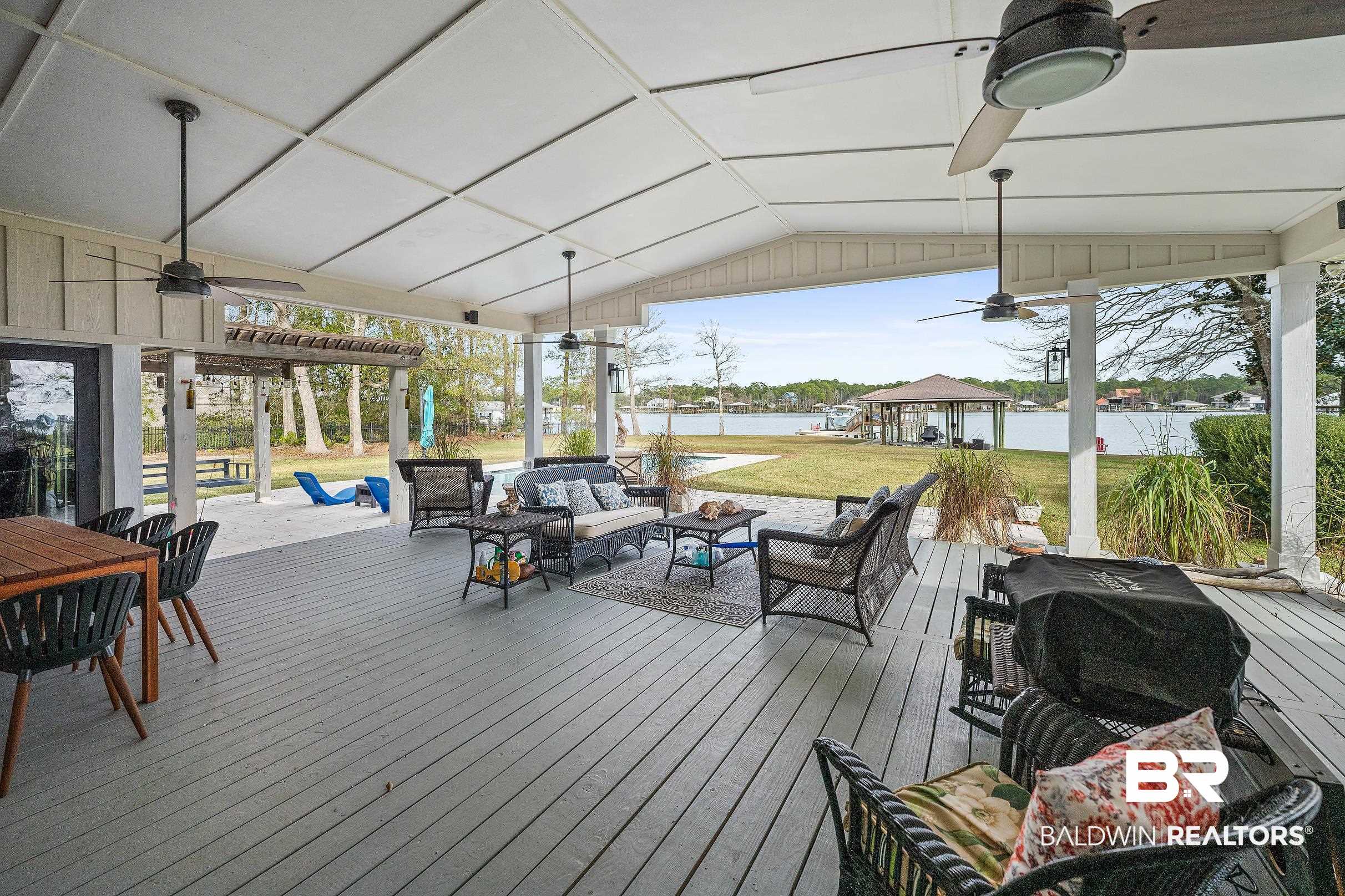 8490 Bay View Drive Foley, AL 36535 - Photo 8 of 67 Wooden terrace with ceiling fan, a water view, outdoor lounge area, and a gazebo