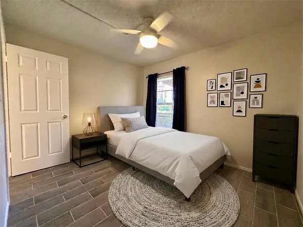 a bedroom with a bed and dresser with mirror