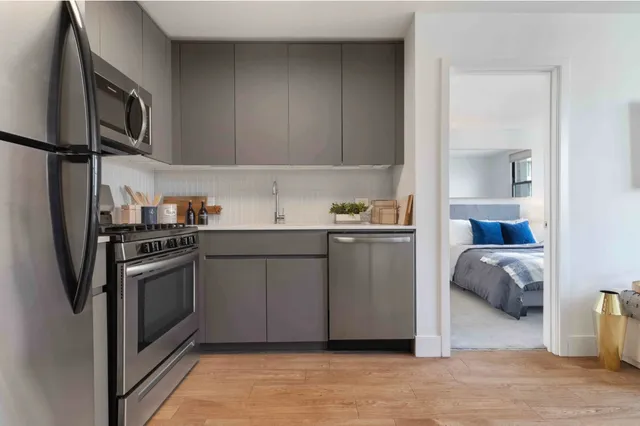 a kitchen with a sink cabinets and stainless steel appliances