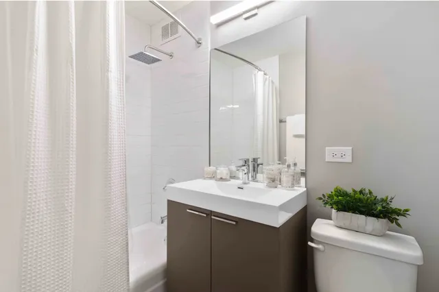 a bathroom with a sink toilet and mirror