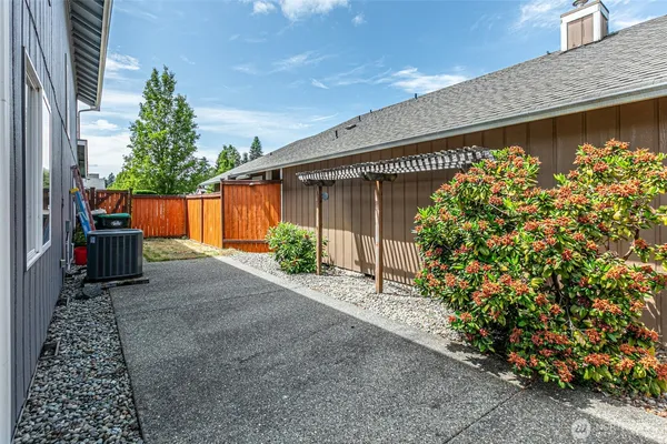 a view of backyard with seating space and trees
