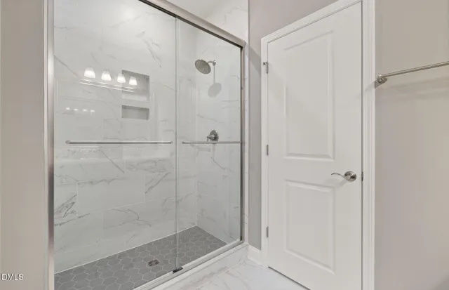 a bathroom with a glass shower door