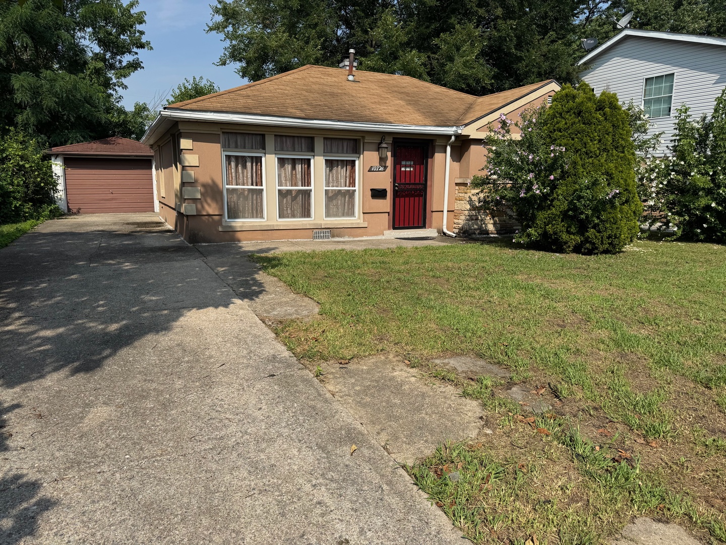 a front view of a house with a garden