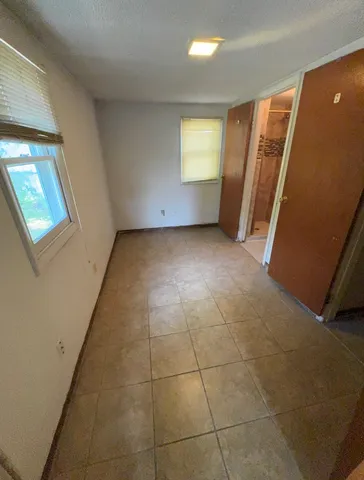 a view of an empty room and a window