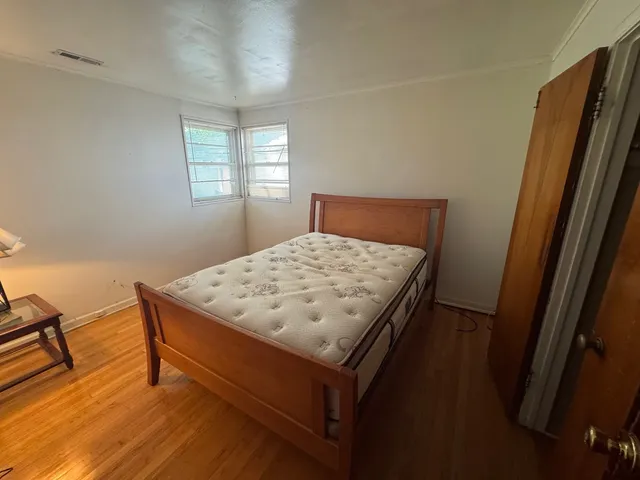 a bed sitting in a bedroom next to a window