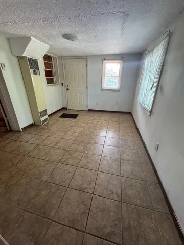 a view of a livingroom with an empty space and window
