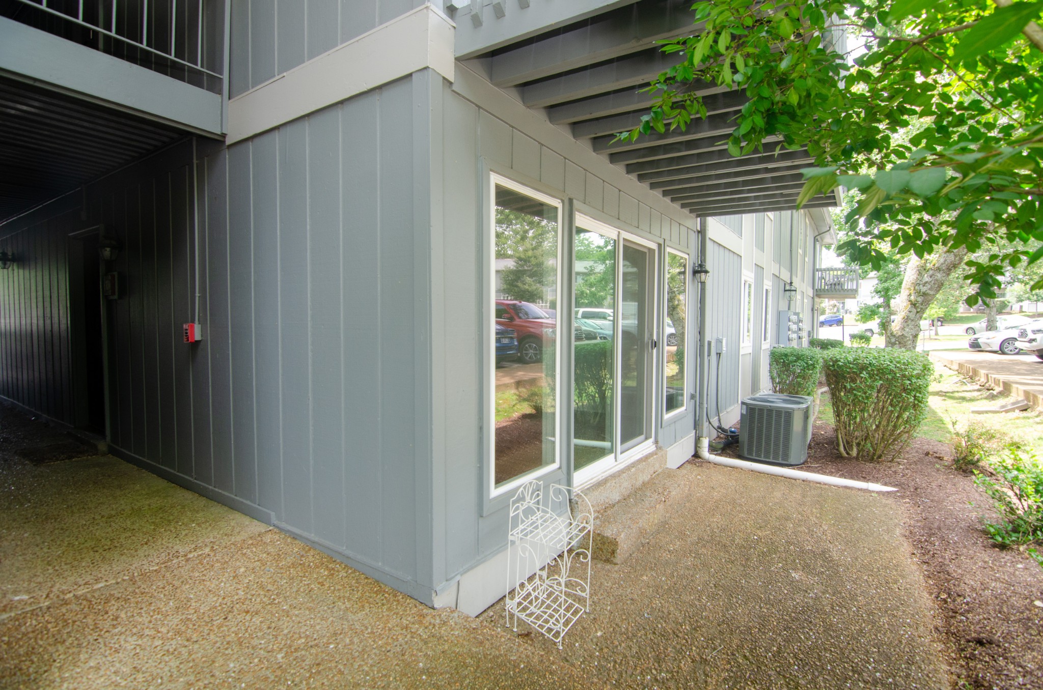 21 Vaughns Gap Road, Unit 110 Nashville, TN 37205 - Photo 1 of 19 a view of a porch with wooden floor and floor to ceiling window and wooden fence