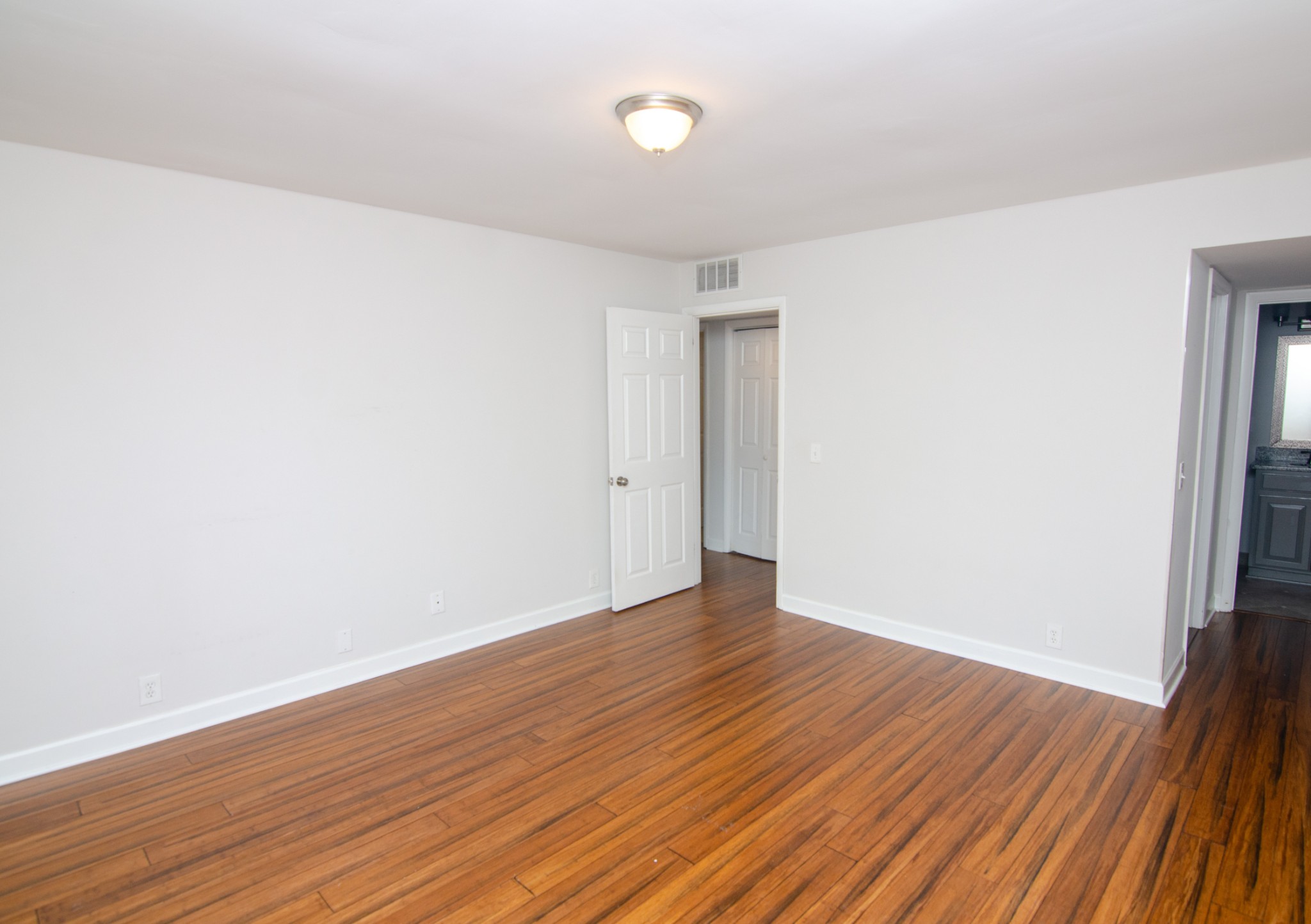21 Vaughns Gap Road, Unit 110 Nashville, TN 37205 - Photo 12 of 19 a view of an empty room with wooden floor