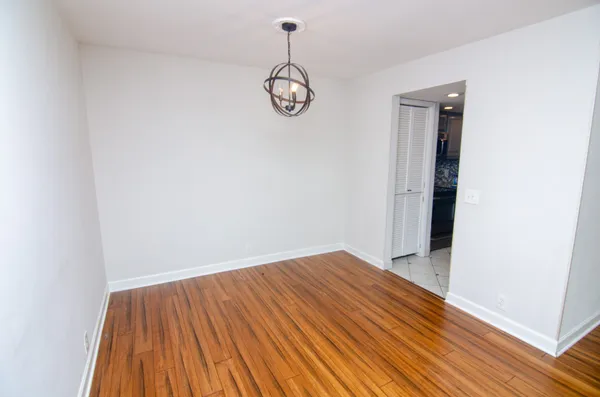 a view of a room with wooden floor