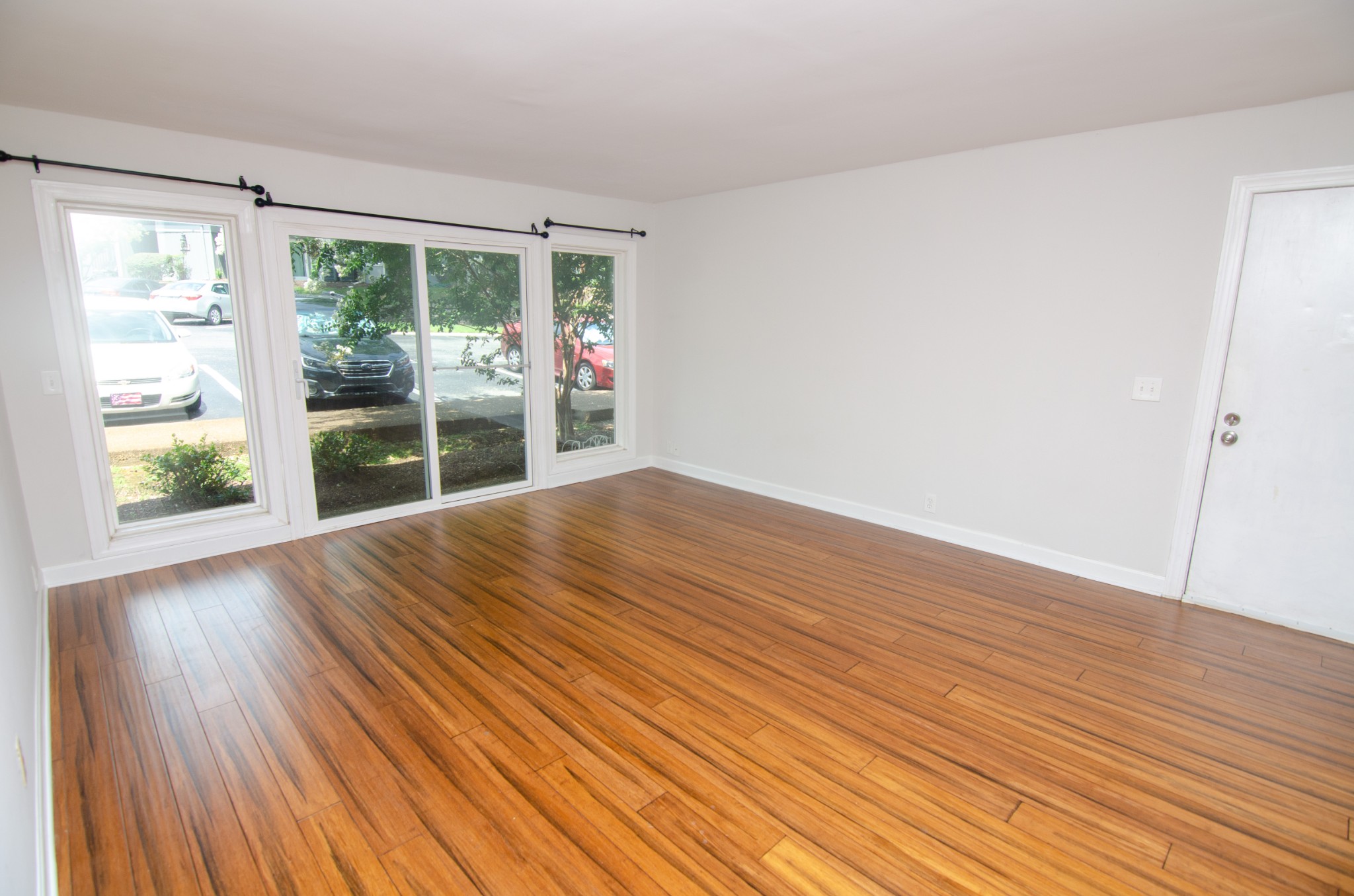 21 Vaughns Gap Road, Unit 110 Nashville, TN 37205 - Photo 3 of 19 a view of empty room with wooden floor and fan