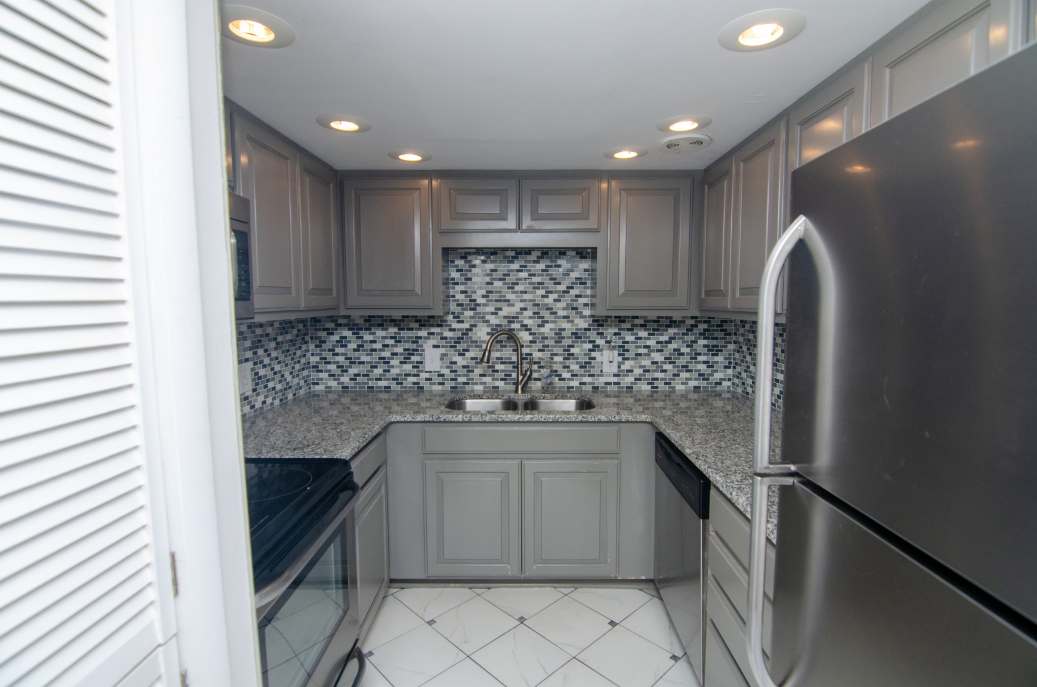 21 Vaughns Gap Road, Unit 110 Nashville, TN 37205 - Photo 5 of 19 a kitchen with a sink stove and cabinets