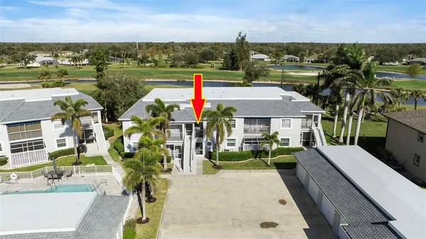 a view of a house with a yard and sitting area