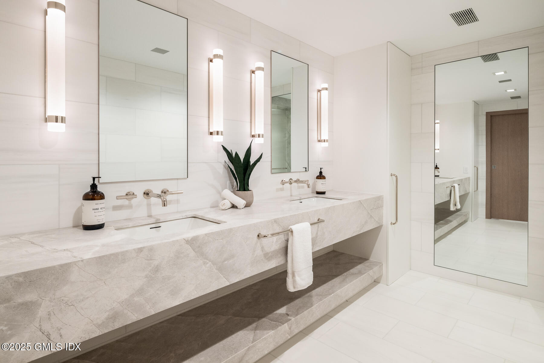 636 Steamboat Road, Unit 3A B & E Greenwich, CT 06830 - Photo 13 of 28 a bathroom with double vanity sinks and a large mirror
