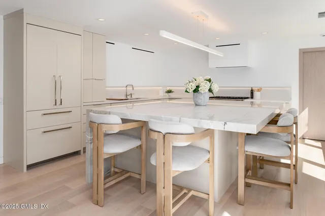 a kitchen with white cabinets and white appliances