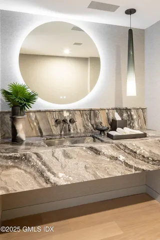 a large white bed sitting in a bedroom next to a window