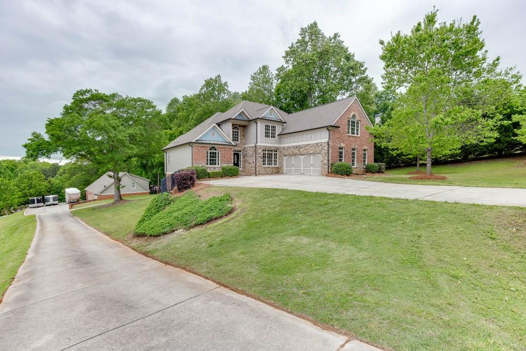 4760 Union Church Road Flowery Branch, GA 30542 - Photo 1 of 1 Front view of the property. Separate driveway leads down to the second garage and apartment.