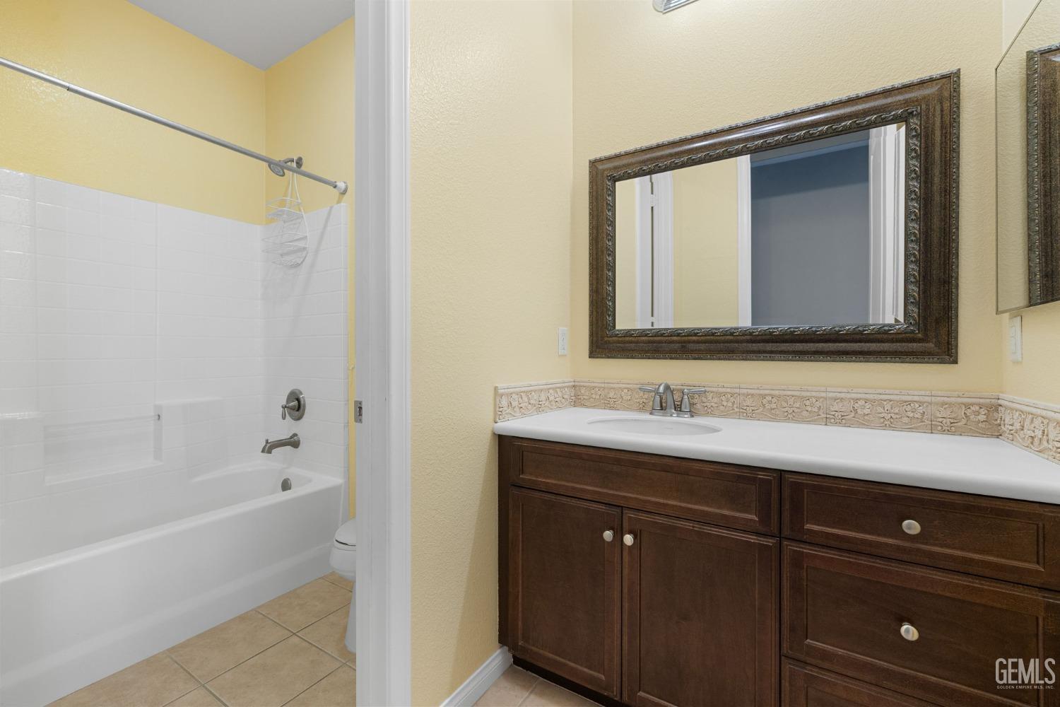 Undisclosed Address Bakersfield, CA 93306 - Photo 20 of 36 a bathroom with a sink and a mirror