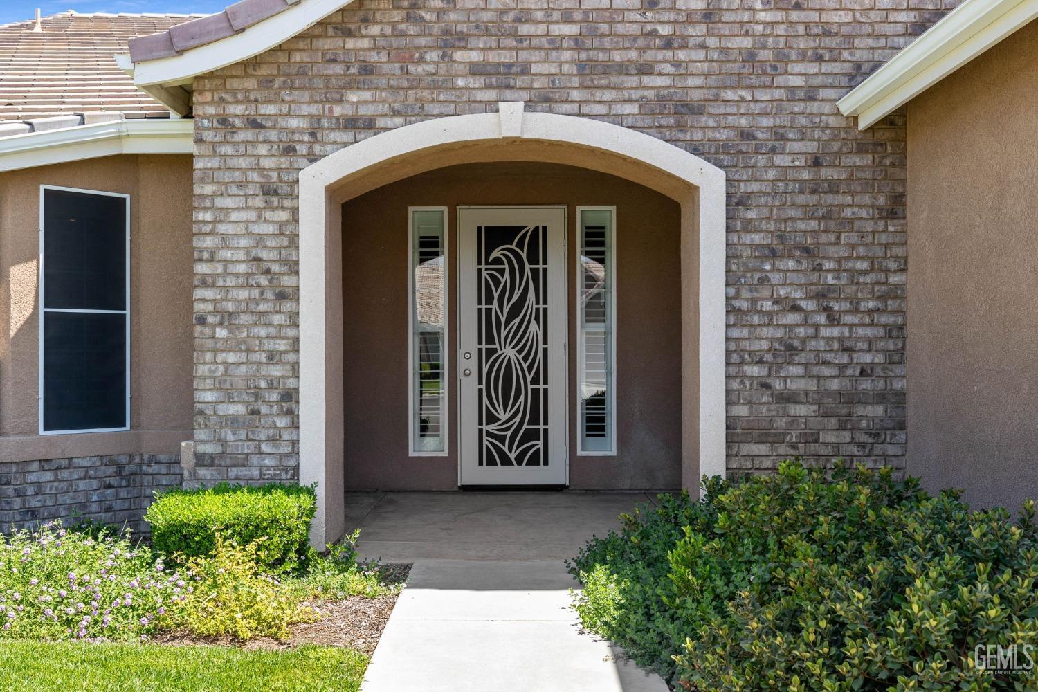 Undisclosed Address Bakersfield, CA 93306 - Photo 2 of 36 a front view of a house with a lots of plants