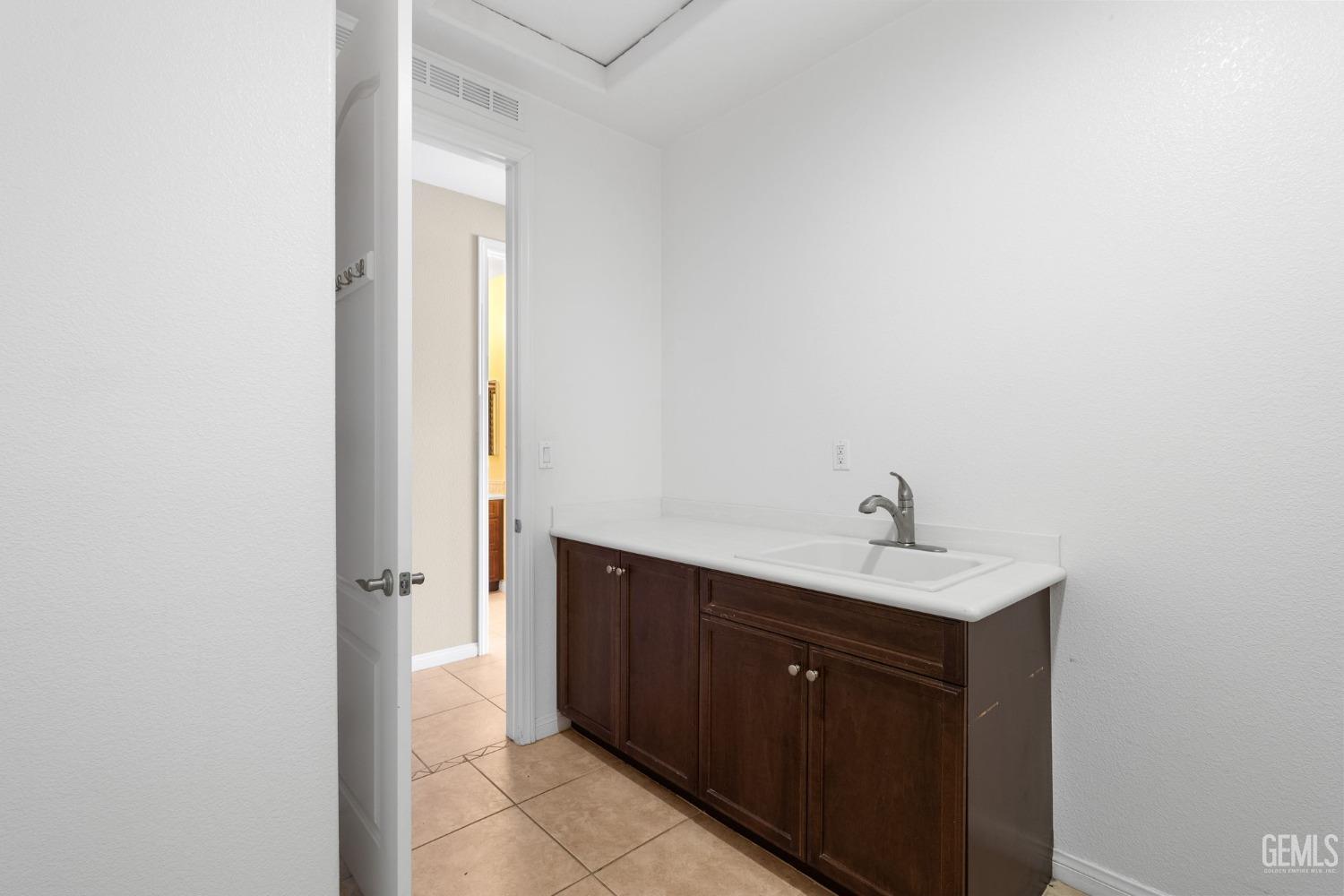 Undisclosed Address Bakersfield, CA 93306 - Photo 21 of 36 a kitchen with a sink and a mirror