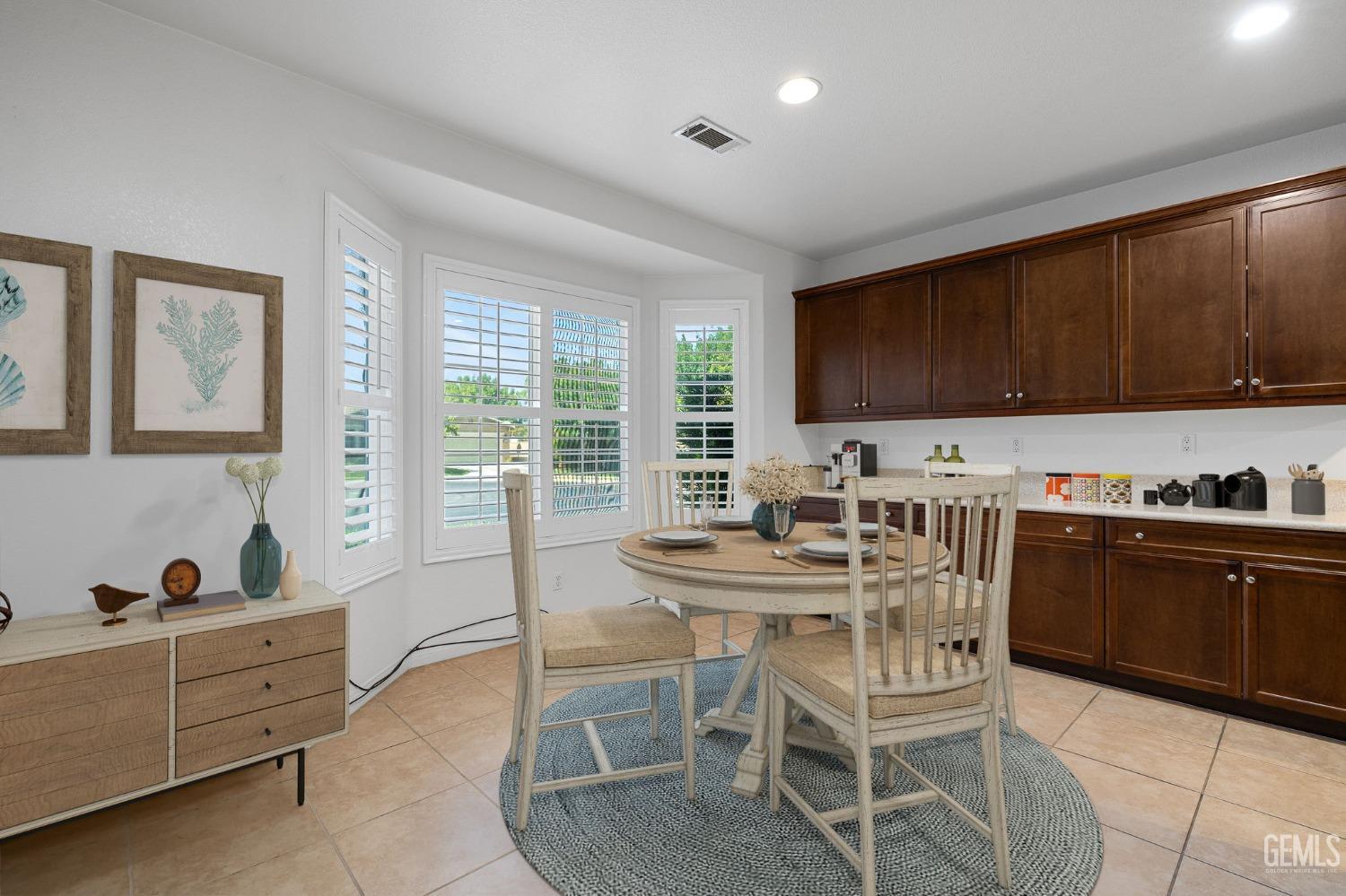 Undisclosed Address Bakersfield, CA 93306 - Photo 6 of 36 a view of a kitchen with a dining table and chairs