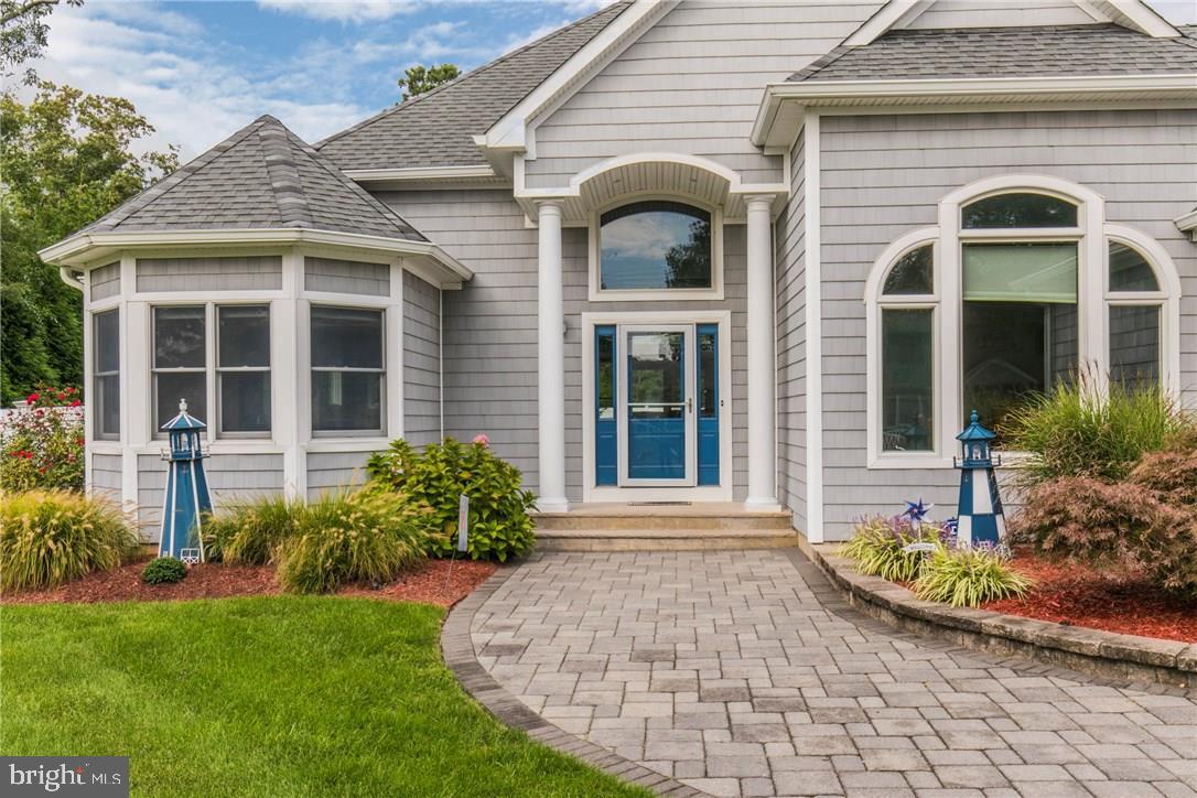 39 Harbor Inn Road Bayville, NJ 08721 - Photo 1 of 27 a front view of a house with garden